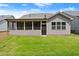 Well-maintained backyard with lush green grass and a screened-in porch for outdoor enjoyment at 207 Hickory Bluffs Pkwy, Canton, GA 30114