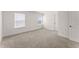 Bright bedroom with plush carpet, and two windows, offering ample natural light at 207 Hickory Bluffs Pkwy, Canton, GA 30114