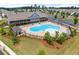 Community pool area featuring a spacious pool deck, comfortable lounge chairs, and a large clubhouse at 207 Hickory Bluffs Pkwy, Canton, GA 30114