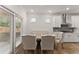 A bright dining area with large windows, hardwood floors, and modern lighting at 207 Hickory Bluffs Pkwy, Canton, GA 30114