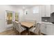 Eat-in kitchen featuring a dining table, hardwood floors, and sliding glass door leading to a patio at 207 Hickory Bluffs Pkwy, Canton, GA 30114