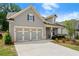 Lovely single-story home with attached two-car garage, landscaped yard, and inviting entryway at 207 Hickory Bluffs Pkwy, Canton, GA 30114