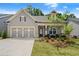 Charming single-story home featuring a well-manicured lawn and a welcoming front porch at 207 Hickory Bluffs Pkwy, Canton, GA 30114