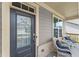 Relaxing front porch featuring wicker chairs and a table with a view of the outdoors at 207 Hickory Bluffs Pkwy, Canton, GA 30114
