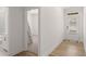 Bright hallway with wood flooring, offering access to a bedroom, bathroom, and backyard at 207 Hickory Bluffs Pkwy, Canton, GA 30114