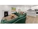 Open-concept living room showcasing a fireplace, hardwood floors, and a glimpse into the kitchen at 207 Hickory Bluffs Pkwy, Canton, GA 30114