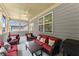 Covered porch featuring comfortable wicker furniture and views of the neighborhood at 207 Hickory Bluffs Pkwy, Canton, GA 30114