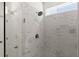 Modern shower featuring marble-style tile, a rainfall shower head, and a glass door at 207 Hickory Bluffs Pkwy, Canton, GA 30114