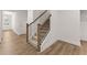 A staircase with hardwood flooring on the first floor with a view of the entry way at 207 Hickory Bluffs Pkwy, Canton, GA 30114