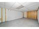 Unfinished basement with exposed studs, concrete floor, and drop ceiling at 9 Latimer Rd, Cartersville, GA 30121