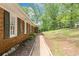 Charming exterior view of a brick home with green shutters and mature landscaping at 9 Latimer Rd, Cartersville, GA 30121