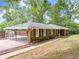 Exterior view of a home with a carport, brick facade, and well-maintained landscaping at 9 Latimer Rd, Cartersville, GA 30121