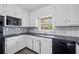 Kitchen featuring white cabinets, black countertops, modern appliances, and neutral walls at 9 Latimer Rd, Cartersville, GA 30121