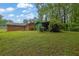 This large backyard includes a storage shed and covered patio, providing plenty of space for outdoor activities and storage at 1125 Lanier Sw Dr, Marietta, GA 30060
