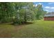 A sprawling backyard with mature trees, creating a private and serene outdoor space perfect for relaxation and entertainment at 1125 Lanier Sw Dr, Marietta, GA 30060