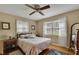 Comfortable bedroom with hardwood floors and a ceiling fan with decorative furnishings at 1125 Lanier Sw Dr, Marietta, GA 30060