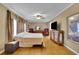 Bright bedroom with hardwood floors, ceiling fan, and ample natural light at 1125 Lanier Sw Dr, Marietta, GA 30060