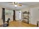Cozy bedroom featuring a ceiling fan, wood floors, and an adjacent bathroom at 1125 Lanier Sw Dr, Marietta, GA 30060