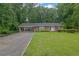 Charming brick home featuring a well-manicured lawn and attached carport at 1125 Lanier Sw Dr, Marietta, GA 30060