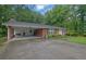 Quaint brick home with a convenient carport and lush green lawn at 1125 Lanier Sw Dr, Marietta, GA 30060