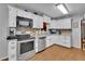 Modern kitchen with stainless steel appliances, light cabinets, and tile backsplash at 1125 Lanier Sw Dr, Marietta, GA 30060