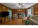 Spacious living room with a fireplace, wood paneling, and views through large windows at 1125 Lanier Sw Dr, Marietta, GA 30060