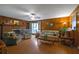 Spacious living room featuring a brick fireplace, wood paneling, and comfortable seating at 1125 Lanier Sw Dr, Marietta, GA 30060