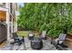 Relaxing backyard space with pavers, gravel, comfortable seating, a fire pit, and lush greenery for privacy at 1626 Gilstrap Nw Ln, Atlanta, GA 30318