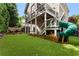Landscaped backyard featuring a fun green slide and outdoor entertaining area at 1626 Gilstrap Nw Ln, Atlanta, GA 30318