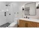Modern bathroom with glass enclosed shower, new fixtures, and wood vanity at 1626 Gilstrap Nw Ln, Atlanta, GA 30318