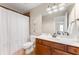 Bathroom with a wood vanity, sink, shower, and curtain at 1626 Gilstrap Nw Ln, Atlanta, GA 30318