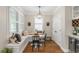 Cozy breakfast nook with a built-in bench, round table, and modern lighting at 1626 Gilstrap Nw Ln, Atlanta, GA 30318