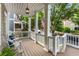 Inviting covered front porch with rocking chairs and stylish lighting at 1626 Gilstrap Nw Ln, Atlanta, GA 30318