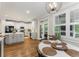 Eat-in kitchen with white cabinets, stainless steel appliances, and a breakfast nook with windows at 1626 Gilstrap Nw Ln, Atlanta, GA 30318