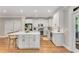 Spacious kitchen featuring white cabinets, stainless appliances, large island and access to outdoor area at 1626 Gilstrap Nw Ln, Atlanta, GA 30318