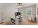 Bright office with shiplap accent wall, modern desk, chair, and ceiling fan at 1626 Gilstrap Nw Ln, Atlanta, GA 30318