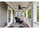 Covered porch with blue wicker furniture, ceiling fan, and white columns at 1626 Gilstrap Nw Ln, Atlanta, GA 30318