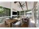 Screened porch with a ceiling fan, comfortable seating, a dining table, and a view of the outdoors at 1626 Gilstrap Nw Ln, Atlanta, GA 30318