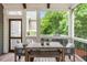 Cozy screened porch with wooden dining table and seating area, perfect for outdoor entertaining at 1626 Gilstrap Nw Ln, Atlanta, GA 30318