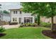 A green and well maintained backyard, and patio area set in a beautiful yard at 172 Olympic Pl, Decatur, GA 30030