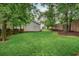 View of a well-manicured backyard featuring a lush lawn and mature trees at 172 Olympic Pl, Decatur, GA 30030