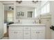 Bathroom with double sink vanity, a large framed mirror, and natural light from the window at 172 Olympic Pl, Decatur, GA 30030