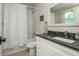 Bathroom featuring a white vanity, dark countertop, framed mirror, and shower with a white curtain at 172 Olympic Pl, Decatur, GA 30030