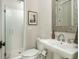 Modern bathroom with a walk-in shower, mosaic mirror, and contemporary fixtures at 172 Olympic Pl, Decatur, GA 30030