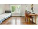 Bright bedroom featuring hardwood floors, natural light from the windows, and a cozy sleeping area at 172 Olympic Pl, Decatur, GA 30030