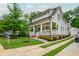 Beautiful two-story home featuring a welcoming front porch, pristine landscaping, and a private driveway leading to a detached garage at 172 Olympic Pl, Decatur, GA 30030
