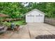 A detached two-car garage and patio area set in a beautiful backyard at 172 Olympic Pl, Decatur, GA 30030