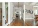 Elegant hallway with hardwood floors, decorative lighting, and neutral wall colors leading to various living spaces at 172 Olympic Pl, Decatur, GA 30030
