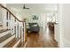 Spacious open-concept living area with hardwood floors, a staircase, and a glimpse into the modern kitchen at 172 Olympic Pl, Decatur, GA 30030