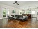 Spacious living room features a large leather sectional, open floor plan, and hardwood flooring at 172 Olympic Pl, Decatur, GA 30030